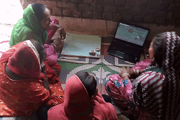 The facilitator guides the study participant (both hail from the same village) on using the system